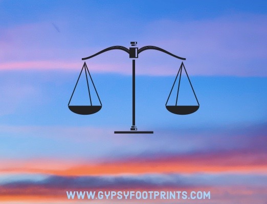 Weighted scales on a sunset background.